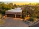 Street view of home with a desert landscape, rock accents, and a three-car garage at 1084 N Boulder Dr, Carefree, AZ 85377
