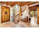 Spacious foyer featuring stone floors, wood beam ceilings, and a unique spiral staircase at 1084 N Boulder Dr, Carefree, AZ 85377