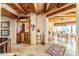 Spacious foyer featuring stone floors, wood beam ceilings, and a unique spiral staircase at 1084 N Boulder Dr, Carefree, AZ 85377