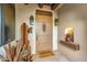 Inviting entryway featuring decorative cactus art, a welcome mat, and exterior lanterns at 1084 N Boulder Dr, Carefree, AZ 85377
