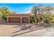 Exterior shot of property, featuring large garage with adobe accents and desert landscaping at 1084 N Boulder Dr, Carefree, AZ 85377