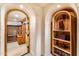 Arched hallway features built-in shelving nooks and opens to other rooms at 1084 N Boulder Dr, Carefree, AZ 85377