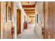 Hallway featuring wood ceiling beams and doors, as well as neutral colored carpet at 1084 N Boulder Dr, Carefree, AZ 85377