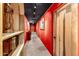 Hallway features red walls, black ceiling, wood trim, art and stone floors at 1084 N Boulder Dr, Carefree, AZ 85377