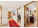 Hallway featuring tile floors, wooden doors, southwestern decor and an open doorway to a bedroom at 1084 N Boulder Dr, Carefree, AZ 85377
