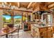 Well-appointed kitchen with stainless steel appliances, wooden island, and a view of the outdoor area and a pool at 1084 N Boulder Dr, Carefree, AZ 85377