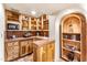 Cozy kitchenette features tile countertops, wood cabinets and arched shelving at 1084 N Boulder Dr, Carefree, AZ 85377