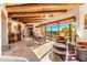 Open-concept living and dining area with views, flagstone floors, and a beamed ceiling at 1084 N Boulder Dr, Carefree, AZ 85377