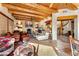 Open concept living room featuring flagstone floors, a fireplace, and a wooden beamed ceiling at 1084 N Boulder Dr, Carefree, AZ 85377