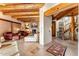 Inviting living room with a fireplace, wood beam ceiling, and beautiful staircase at 1084 N Boulder Dr, Carefree, AZ 85377