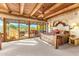 Bright main bedroom with a rustic wood ceiling, plush carpet and outdoor patio access at 1084 N Boulder Dr, Carefree, AZ 85377