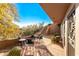 Charming outdoor patio with flagstone and rustic furniture, and desert landscaping at 1084 N Boulder Dr, Carefree, AZ 85377
