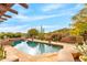 Beautiful backyard pool and desert landscaping with mountain views and an outdoor living space at 1084 N Boulder Dr, Carefree, AZ 85377