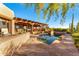 Picturesque pool and patio area featuring desert landscaping, an outdoor kitchen, and comfortable seating at 1084 N Boulder Dr, Carefree, AZ 85377