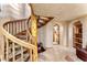 Unique wood spiral staircase in hall leads to upper floors and is naturally lit at 1084 N Boulder Dr, Carefree, AZ 85377