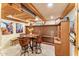 Inviting wine tasting room with rustic decor, seating for four, and built-in wine racks at 1084 N Boulder Dr, Carefree, AZ 85377