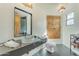 Stylish bathroom featuring a modern vanity, vessel sink, and unique wood doors at 11505 E Cochise Dr, Scottsdale, AZ 85259