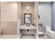 Stylish bathroom featuring stone countertops, mosaic tile accent wall, and modern fixtures at 11505 E Cochise Dr, Scottsdale, AZ 85259