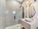 Modern bathroom boasts a glass shower and stone vessel sink at 11505 E Cochise Dr, Scottsdale, AZ 85259