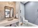 Stylish bathroom featuring stone countertops, mosaic tile accent wall, and modern fixtures at 11505 E Cochise Dr, Scottsdale, AZ 85259