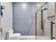 Modern bathroom with a glass-enclosed shower, gray tile and neutral walls at 11505 E Cochise Dr, Scottsdale, AZ 85259