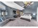 Spacious bedroom with high ceilings, statement chandelier, and comfortable sitting area at 11505 E Cochise Dr, Scottsdale, AZ 85259