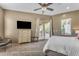 Cozy bedroom featuring a comfortable bed, soft lighting, and a view to the outside patio at 11505 E Cochise Dr, Scottsdale, AZ 85259