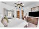 Bright bedroom with neutral walls, ceiling fan and mirrored closet doors at 11505 E Cochise Dr, Scottsdale, AZ 85259