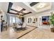 Spacious dining room featuring a coffered ceiling, elegant chandelier, and modern furnishings at 11505 E Cochise Dr, Scottsdale, AZ 85259