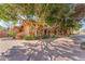 Elegant home with mature trees, beautiful landscaping, and a circular driveway at 11505 E Cochise Dr, Scottsdale, AZ 85259