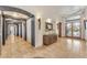 Elegant foyer with arched doorways, stylish lighting, and a decorative display cabinet at 11505 E Cochise Dr, Scottsdale, AZ 85259