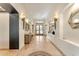 Bright foyer with decorative lighting, tile flooring, and a glimpse of the outdoors at 11505 E Cochise Dr, Scottsdale, AZ 85259