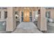 Elegant arched wood front door with sidelights and stone pathway leading to the entrance at 11505 E Cochise Dr, Scottsdale, AZ 85259