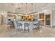 Open kitchen with large island, pendant lighting, stainless steel appliances and tile flooring at 11505 E Cochise Dr, Scottsdale, AZ 85259