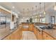 Gourmet kitchen featuring custom cabinetry, stone countertops, and professional-grade appliances at 11505 E Cochise Dr, Scottsdale, AZ 85259