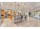 Open-concept kitchen with a large island, pendant lighting, and stainless steel appliances at 11505 E Cochise Dr, Scottsdale, AZ 85259