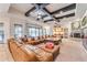 Comfortable living room featuring exposed beams, fireplace, and a large sectional sofa at 11505 E Cochise Dr, Scottsdale, AZ 85259