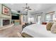 Spacious main bedroom boasts a brick fireplace, ceiling fan, and sliding glass door to the backyard at 11505 E Cochise Dr, Scottsdale, AZ 85259