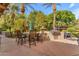 Outdoor patio with a built-in BBQ area, lush greenery, and comfortable seating at 11505 E Cochise Dr, Scottsdale, AZ 85259