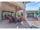 Inviting covered patio features a dining area with stylish chandelier and comfortable seating at 11505 E Cochise Dr, Scottsdale, AZ 85259
