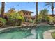 Backyard pool area with lush landscaping and a waterfall feature at 11505 E Cochise Dr, Scottsdale, AZ 85259