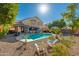 Lush backyard featuring a swimming pool, spa, pergola, and inviting desert landscape at 11866 N 143Rd Ave, Surprise, AZ 85379