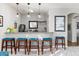 Stylish bar area with granite countertop, pendant lights, and seating for four at 11866 N 143Rd Ave, Surprise, AZ 85379