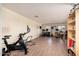Spacious bonus room with a home gym and musical equipment featuring wood-look floors and neutral walls at 11866 N 143Rd Ave, Surprise, AZ 85379