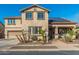 Beautiful two-story home featuring a desert landscape, solar panels, and a charming front porch at 11866 N 143Rd Ave, Surprise, AZ 85379