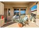 Inviting covered front porch with seating and potted plants, creating a welcoming entrance at 11866 N 143Rd Ave, Surprise, AZ 85379