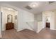 Hallway landing area boasts hardwood floors, neutral walls, and seamless access to other rooms at 11866 N 143Rd Ave, Surprise, AZ 85379