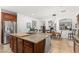 Expansive kitchen island with granite countertop, cabinetry, and seating at 11866 N 143Rd Ave, Surprise, AZ 85379