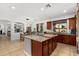 Bright kitchen boasts granite counters, stainless appliances, tile flooring, and a large island at 11866 N 143Rd Ave, Surprise, AZ 85379