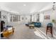 Bright and airy living room with large windows, plush seating, and modern accents at 11866 N 143Rd Ave, Surprise, AZ 85379